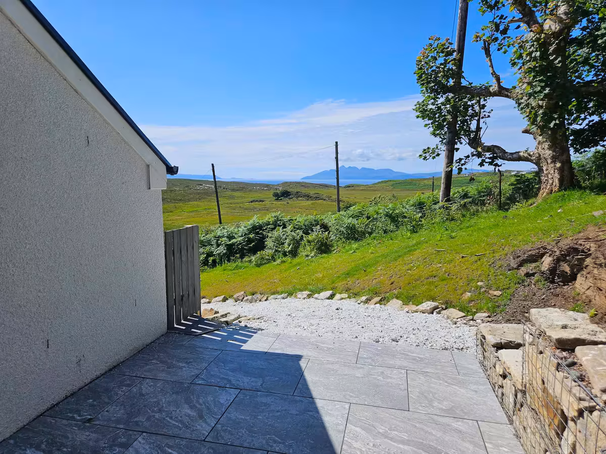 Rear garden with patio area at Hillside House